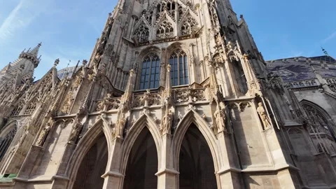 Cinematic slow motion low-angle footage of a historic cathedral facade in Vienna Stock Footage 343230353