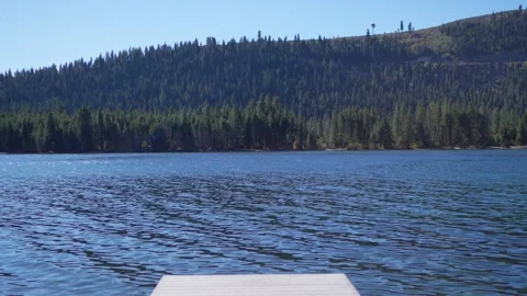 Cinematic Slow Motion Move Forward On Pier Toward Alpine Lake Stockbeeldmateriaal 334342607