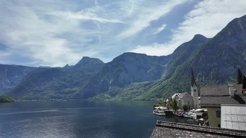Cinematic slow motion reflection shot of Hallstatt Protestant church and lake Stock Footage 344892950