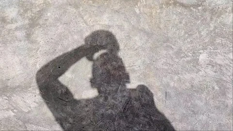 Cinematic Slow Motion Shadow of Man Putting on Hat - 1080p Video stock 334628378
