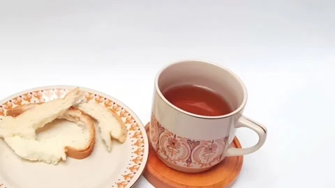 Cinematic slow motion shot of black coffee cup and torn bread Stock Footage 344782736