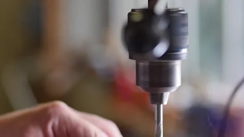 Cinematic slow motion shot of drill chuck drilling wooden piece. handmade wooden Stock Footage 140977477