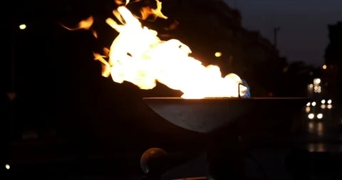 Cinematic slow motion shot of fire pot torch burning with car lights in Stock Footage 122181747