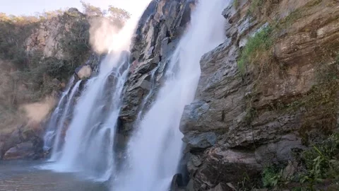 Cinematic Slow Motion Tilt Down Following A Powerful Waterfall Cascade with gold Stock Footage 340470396