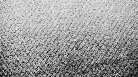 Cinematic slow motion tracking over soft textured gray cotton towel fabric revea 스톡 동영상 337550499