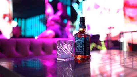 Cinematic Slowmotion 4K Jack Daniels whiskey is on the table in the nightclub Stock Footage 252590552