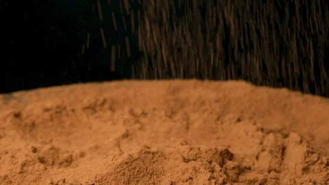 Cinematic sprinkle of raw cocoa powder on black background slow motion Stock Footage 334873122