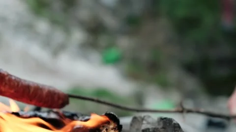Cinematic stable slw motion shot of a sausage being barbequed with a stick in Stock Footage 131835731