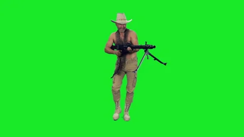 Cinematic style of daring bare-chested man shooting machine gun on green screen 스톡 동영상 304992566