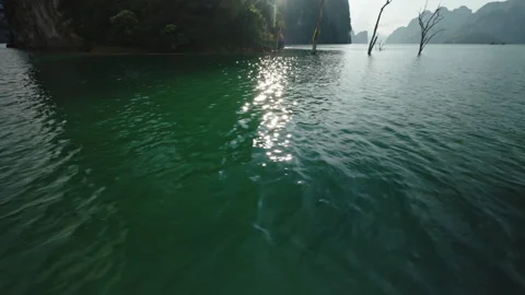 Cinematic Sun Flare Piercing Through Tropical Karst Mountains Over Cheow Lan Stock-Footage 334680482