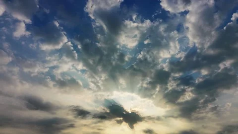 Cinematic sunbeams breaking through dramatic clouds in blue sky at sunrise Vídeos de archivo 336040604