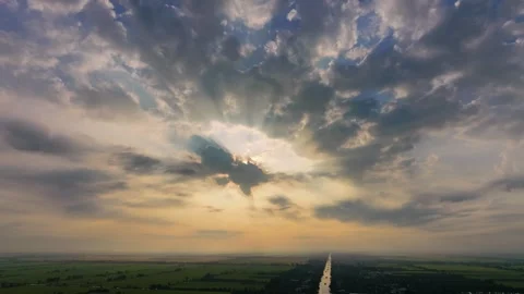 Cinematic sunbeams breaking through dramatic clouds over Mekong Delta at dawn Vídeos de archivo 336040605