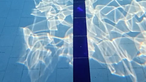 Cinematic Sunlight Caustics Moving Across Swimming Pool Bottom Stock Footage 340899401