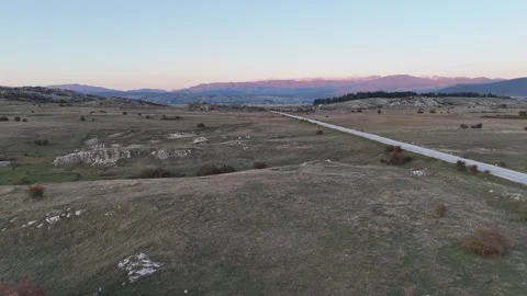 Cinematic Sunset Drone Flight Over a Countryside Highway and Balkan Mountains Vídeo Stock 331869206