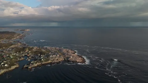 Cinematic Sunset Drone Shot Of Lighthouse On Rugged Shore In Nova Scotia, Canada Stock Footage 314464372