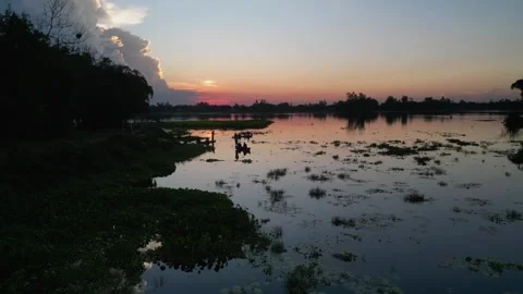 Cinematic sunset over calm river with cloud reflection and boat silhouette,.. Stock Footage 344768416