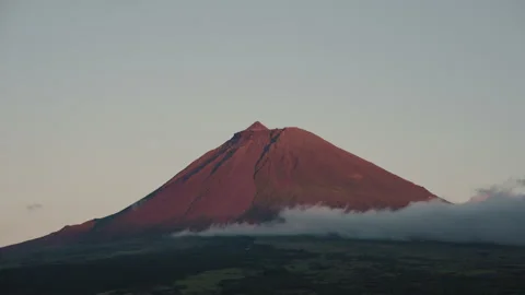 Cinematic Sunset View of Mount Pico Volcanic Peak Glowing in Warm Light Above Video stock 334666133