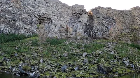 Cinematic tilt and pan of massive rock walls in North Iceland Stock Footage 333474983