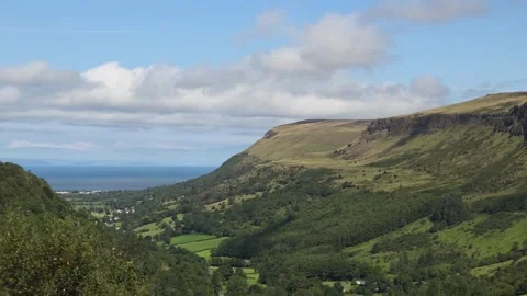 Cinematic time lapse clouds sweep over lush Glenariff hills Stock-Footage 314908124