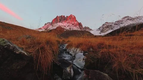 Cinematic time lapse of dramatic red sunset over mountain peak in Juta vall.. Video stock 242453952