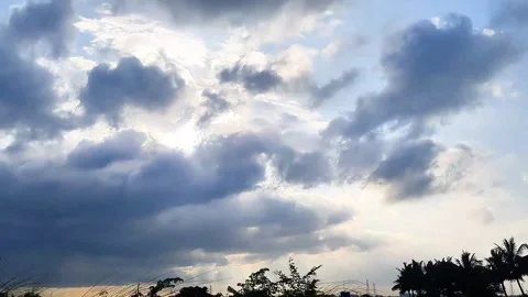 Cinematic time-lapse of fluffy clouds moving across a bright sky. Stock Footage 315359979
