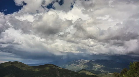 Cinematic time lapse of rainy clouds moving fast above green hills Stock Footage 38242336