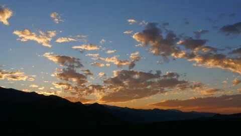 Cinematic time lapse of sunset and clouds over mountains Stock Footage 232500012