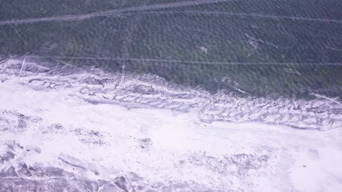 Cinematic top-down drone shot of frozen lake surface and ice textures Stock Footage 336334219