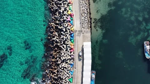 Cinematic Top Down Drone View of Harbor Pier and Turquoise Coastal Water Stock Footage 344778311