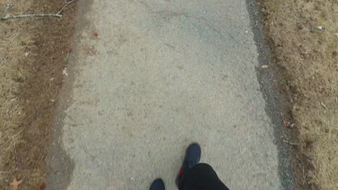 A cinematic top-down shot of a walking trail or dirt road surrounded by dry Stock Footage 331204249