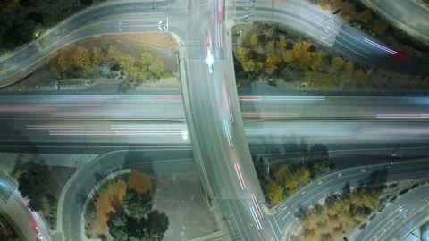 Cinematic top view time-lapse of car traffic at busy highway ramps with lanes Stock Footage 166930128