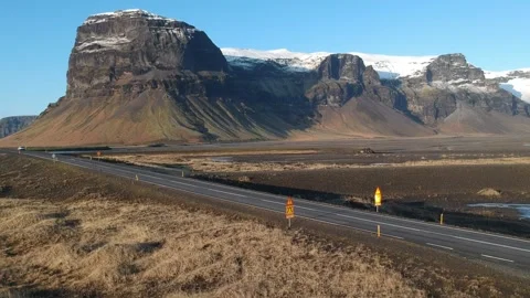 Cinematic tracking view 4WD car drives on Icelandic road with wonderful lands Stock Footage 158170384