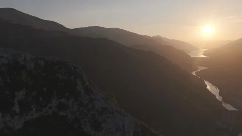 Cinematic Turn Toward Ancient River Valley at Golden Sunset Stock Footage 337463668