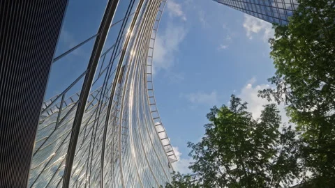 Cinematic upward camera movement between modern skyscrapers and office buildings Stock Footage 335729462