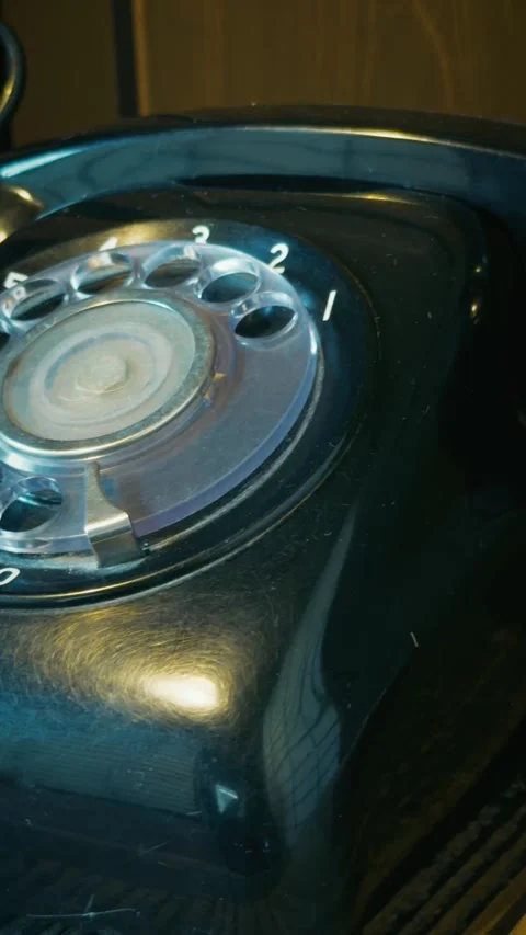 Cinematic vertical close-up panning shot of an old black rotary phone Stock Footage 345457616