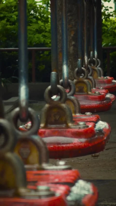 Cinematic vertical close-up of red swing seats folded and secured with Vidéo 345514684