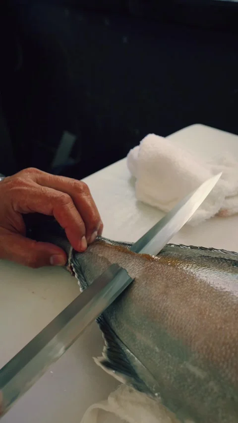Cinematic vertical closeup 4K chef removing bluefin tuna skin Stock Footage 317519075