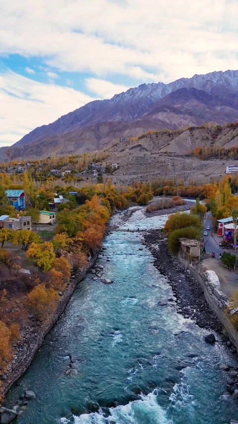 Cinematic vertical drone loop over a bridge in fall-draped Kargil. Stock Footage 310665076