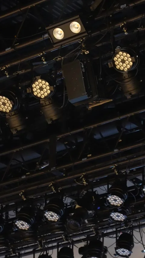 Cinematic vertical pan of massive black stage lighting truss setup Stock Footage 345700733