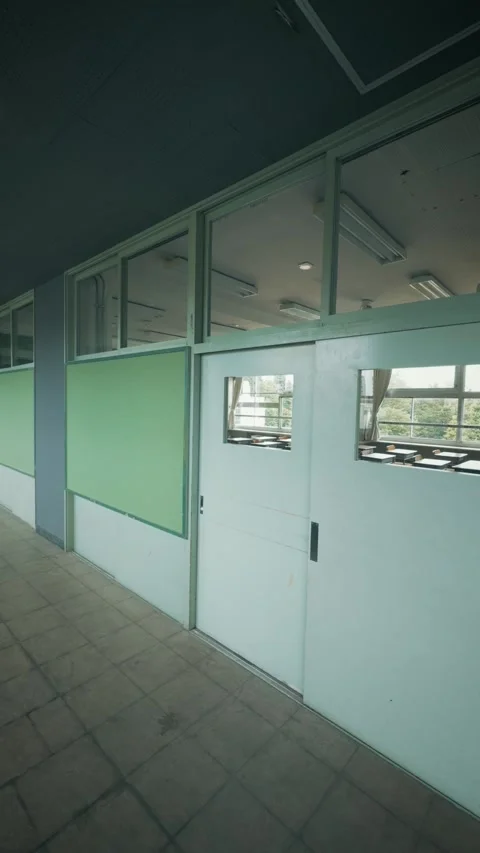 Cinematic vertical shot of an empty Japanese school hallway and classroom Stock Footage 345458670