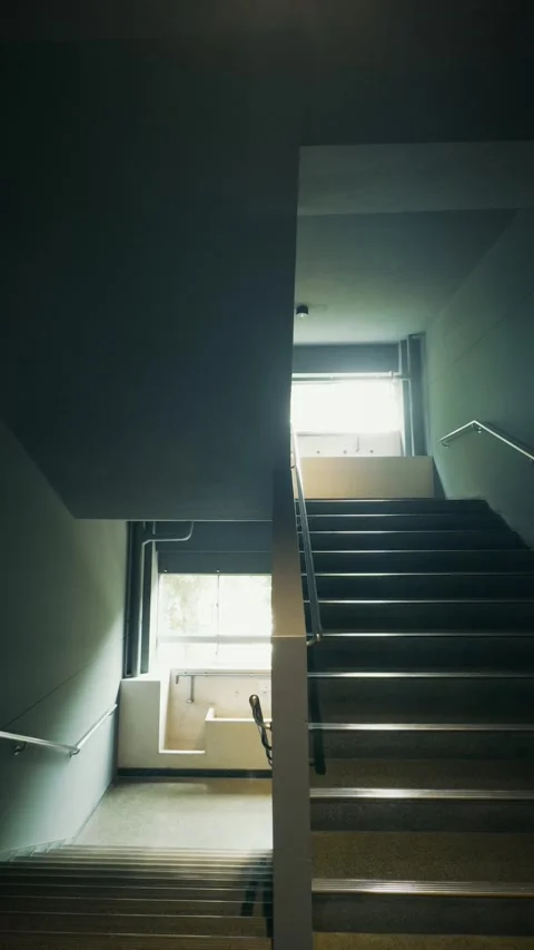 Cinematic vertical shot of a moody empty stairwell in a Japanese public Vidéo 345458657