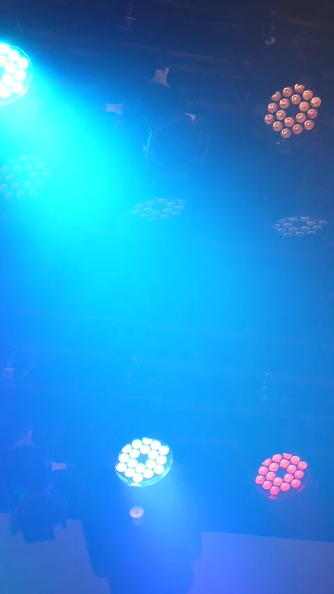 Cinematic vertical view of dynamic colorful LED stage lights rapidly flashing an Vidéo 345706061