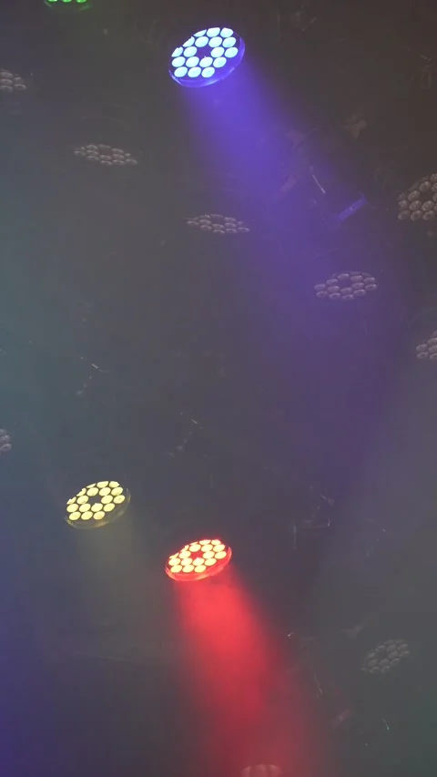 Cinematic vertical view of dynamic multicolor LED stage lights and moving spotli Stock Footage 345707107