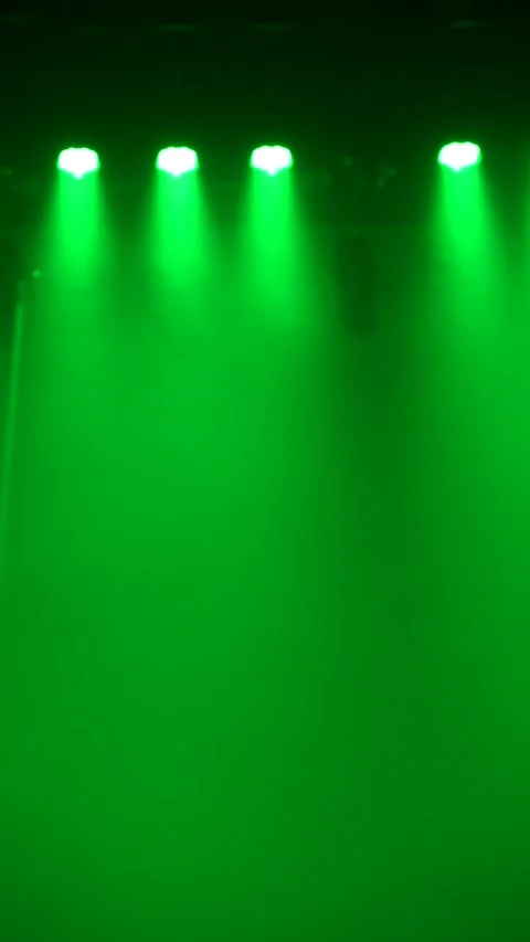Cinematic vertical view of green stage lights illuminating smoke Vidéo 345704510