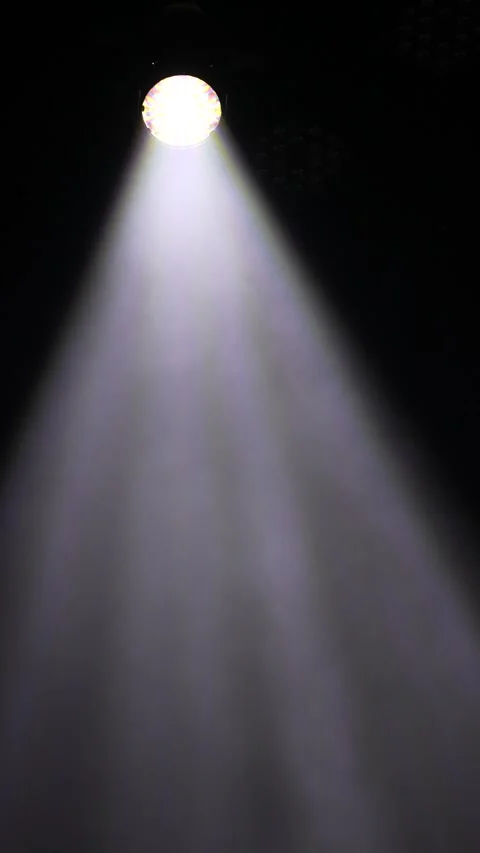 Cinematic vertical view of a powerful single white spotlight shining Vidéo 345704686