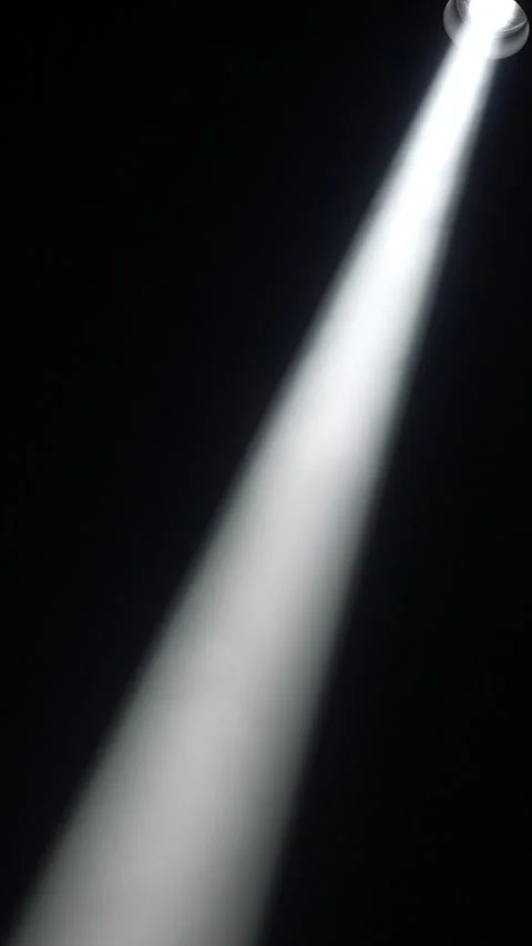 Cinematic vertical view of a powerful white spotlight casting a sharp diagonal l Vidéo 345705655