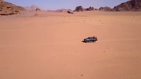 Cinematic view of 360° camera movement on a moving car in desert Stock Footage 103217500