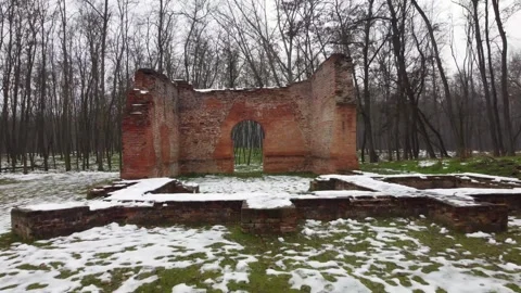 Cinematic View of an Ancient Brick Temple Ruin Amidst a Snowy Winter Forest Stock Footage 294678643