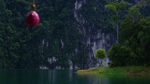 Cinematic view of the islet on the lake with a small wooden house. Stock Footage 82643032