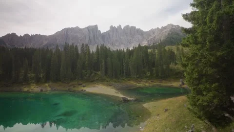 Cinematic view of Lago di Carezza turquoise lake in the Dolomites Italy Stock Footage 320458519